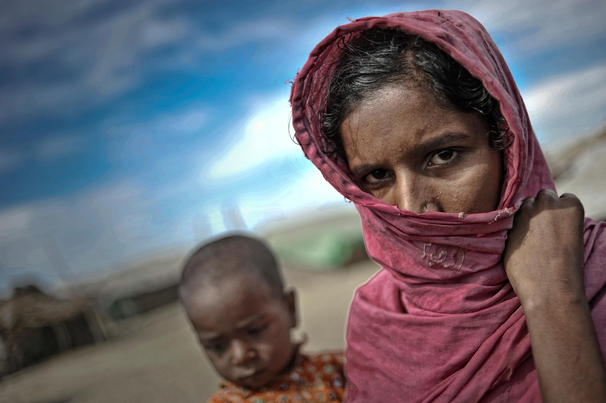 A 25 years old mother holds her child in a refugee camp on the outskirts of Pauk Taw township, February 2013. Photo Kaung Htet A 25 years old mother holds her child in a refugee camp on the outskirts of Pauk Taw township, February 2013. Photo Kaung Htet