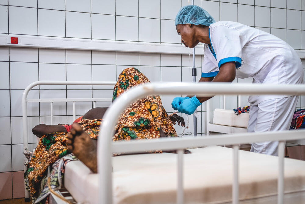 A member of the medical team checks on a patient in the labour ward of the MSF-supported maternity unit