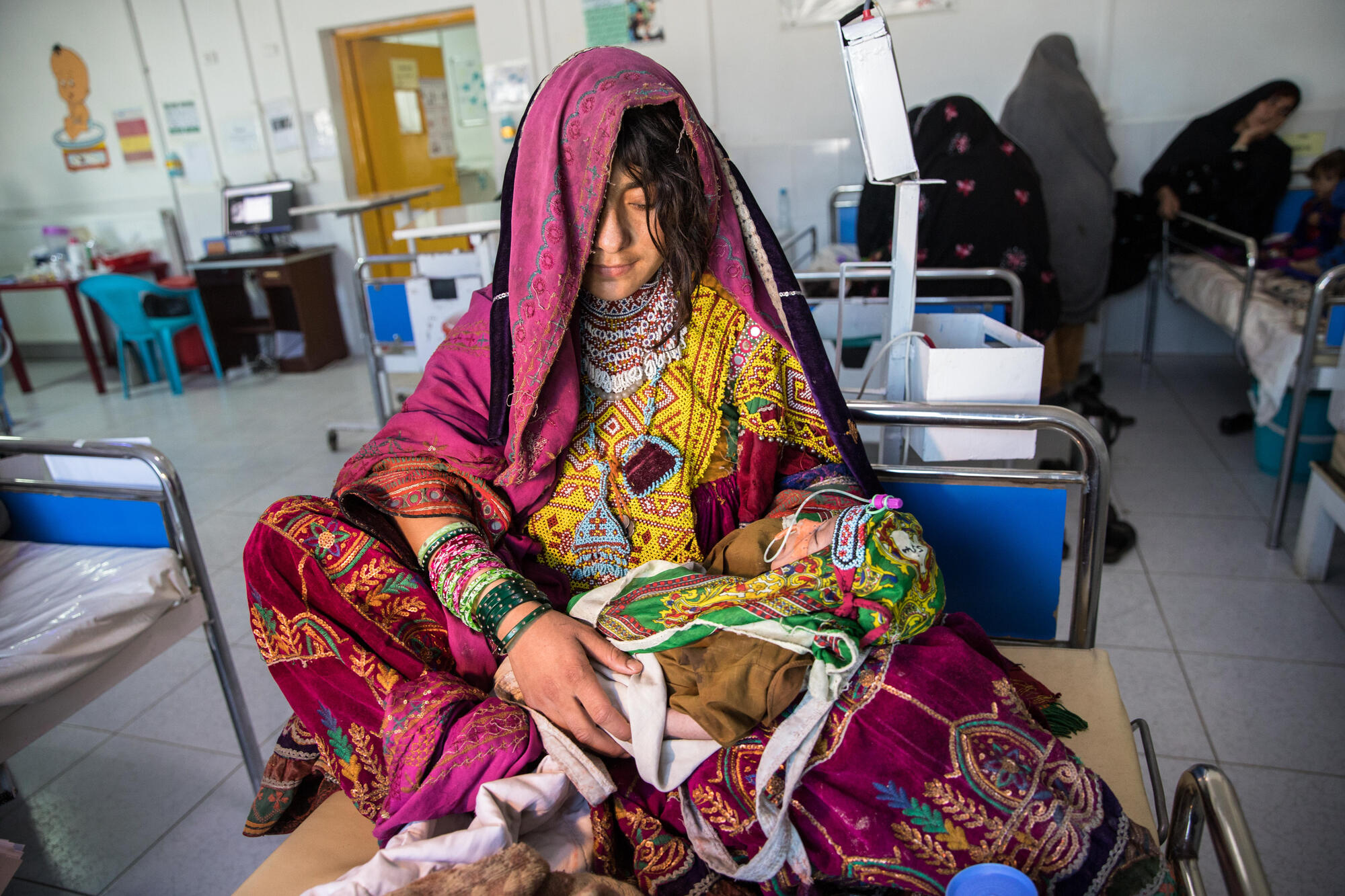 In Boost Hospital's feeding centre, a young mother holds her six-week-old baby who is being treated for malnutrition