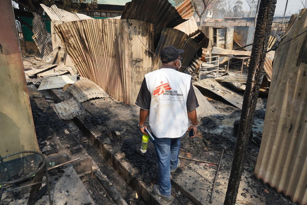 An MSF member of staff surveys the damage to MSF's Balukhali clinic the morning after it was razed to the ground.