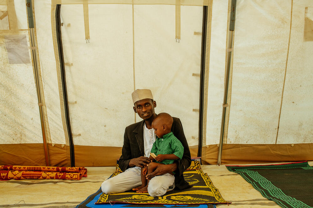 Two-year-old Mohammed Sheriff with his father at a cholera treatment centre