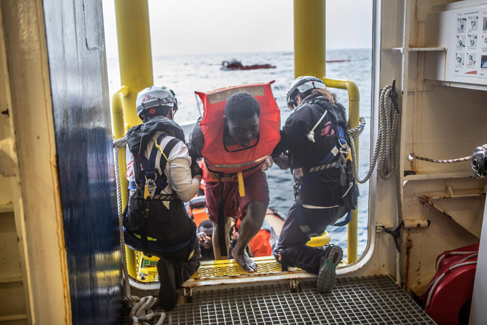 A survivor is helped on board Geo Barents