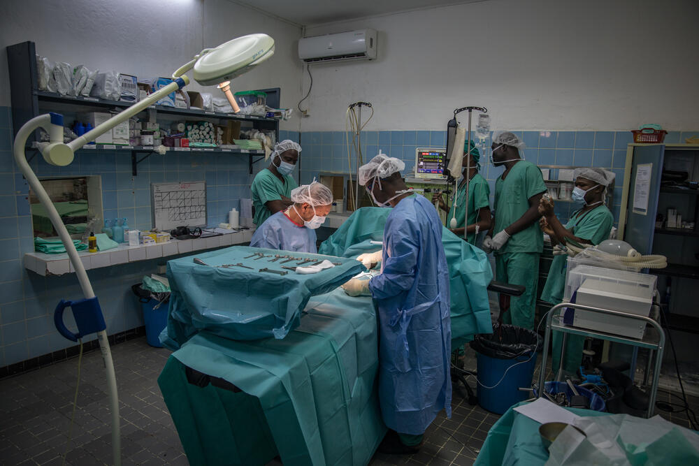 A surgical team in norther Cameroon operate on a two-year-old child with gangrene, a complication of severe malaria.