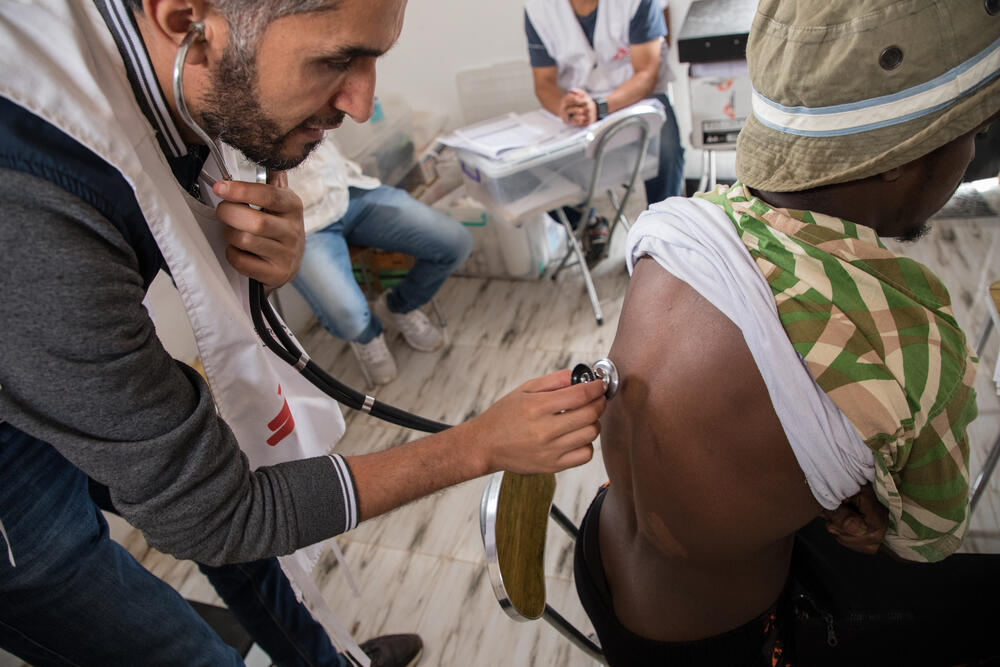 An MSF medic attends to a man In the Dahr-el-Jebel detention centre, near Yefren, Libya. When MSF began working in the centre in May 2019, we were horrified to discover that at least 22 migrants and refugees had died of diseases, mainly tuberculosis. 