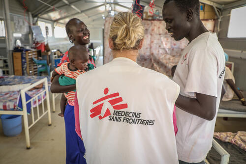 MSF staff discussing with a patient's mother