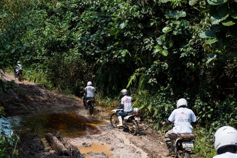 MSF staff travel by motorbike to reach remote villages in DRC.