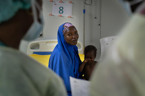 Doctors discuss treatment for measles patient