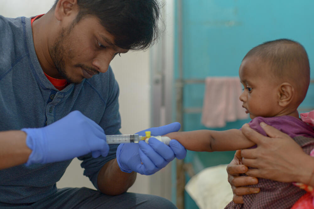 Ten-month-old baby Atiullah was born in the refugee camp in Cox’s Bazar, and is his parents’ only son. He was admitted to MSF’s Kutupalong field hospital suffering from complicated measles and malnutrition. In this photo, an MSF nurse inserts a cannula to administer his treatment.