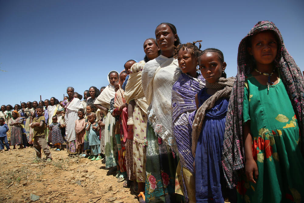 Women wait with their children for a medical consultation during a mobile clinic run by MSF in Adiftaw, a village in northern Ethiopia's Tigray region.
