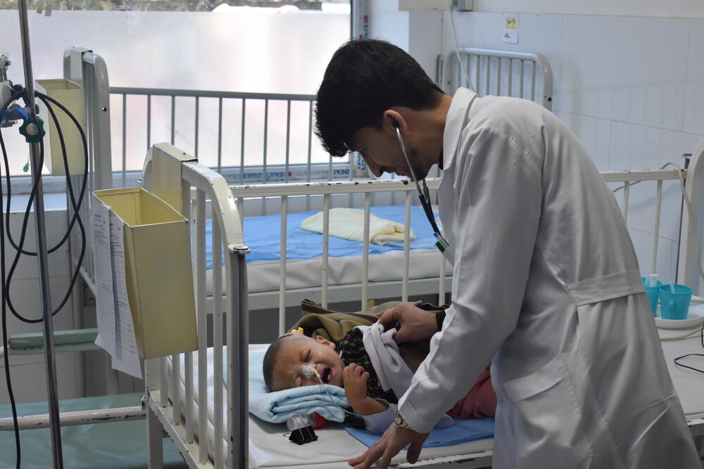 An MSF doctor checks on a malnourished child in the inpatient feeding centre of Herat regional hospital.