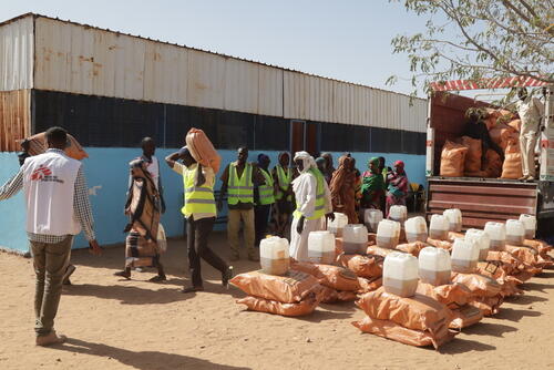 In Sudan, MSF staff distribute food supplies from an MSF facility for malnutrition treatment in South Darfur