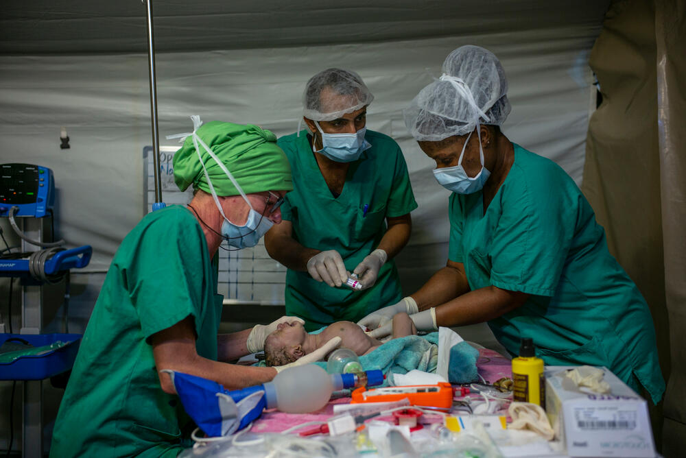 An MSF medical team caring for a baby immediately after caesarean delivery in Yemen