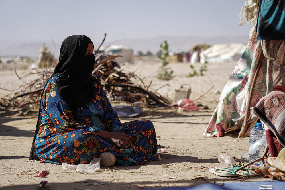 A woman sits outside her family's tent at Al-Khuseif camp in Marib, just a few kilometres away from the frontline