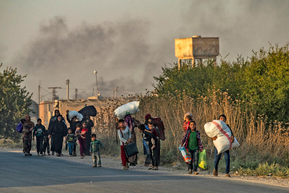October 2019: Families flee heavy shelling from a Turkish military operation in northern Syria