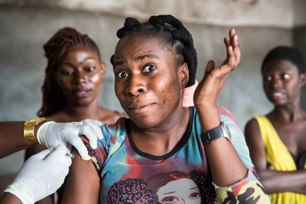 A woman receives a vaccination in Kinshasa, DRC, after an outbreak of yellow fever