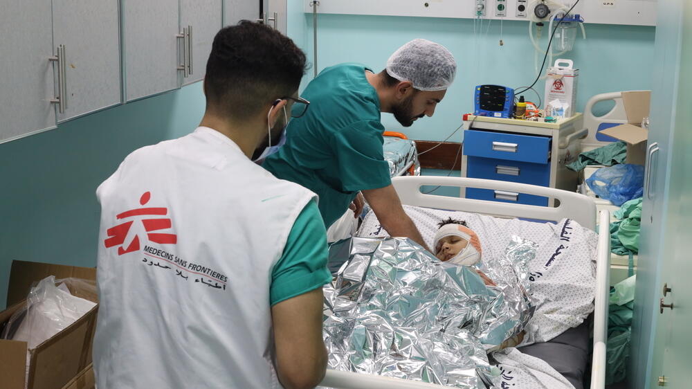 MSF staff and a young patient at Al Shifa hospital, Gaza.
