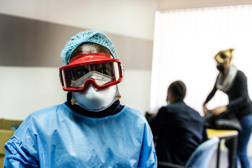 A health worker in PPE is seen at a mass COVID-19 screening and testing which took place in Johannesburg, South Africa where MSF assisted in swabbing people and training health workers on how to properly swab people.