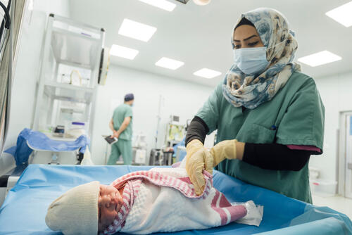 An MSF medical team member cares for a baby born by emergency caesarean section at Nablus Hospital in Mosul An MSF medical team member cares for a baby born by emergency caesarean section at Nablus Hospital in Mosul