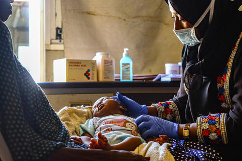 Photo of a baby in a health centre in Darfur, Sudan