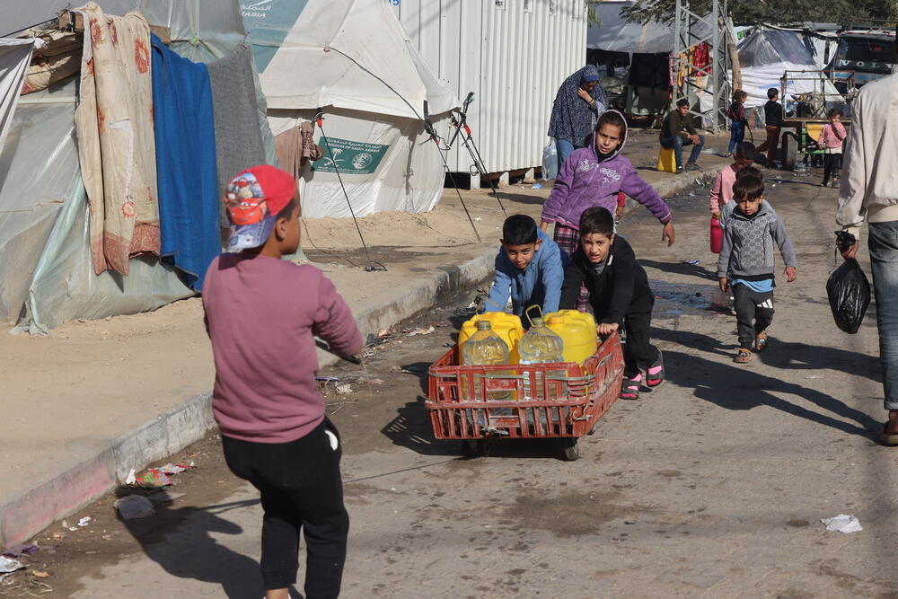 Young Palestinians collecting water in Rafah, now home to 1.5 million displaced people