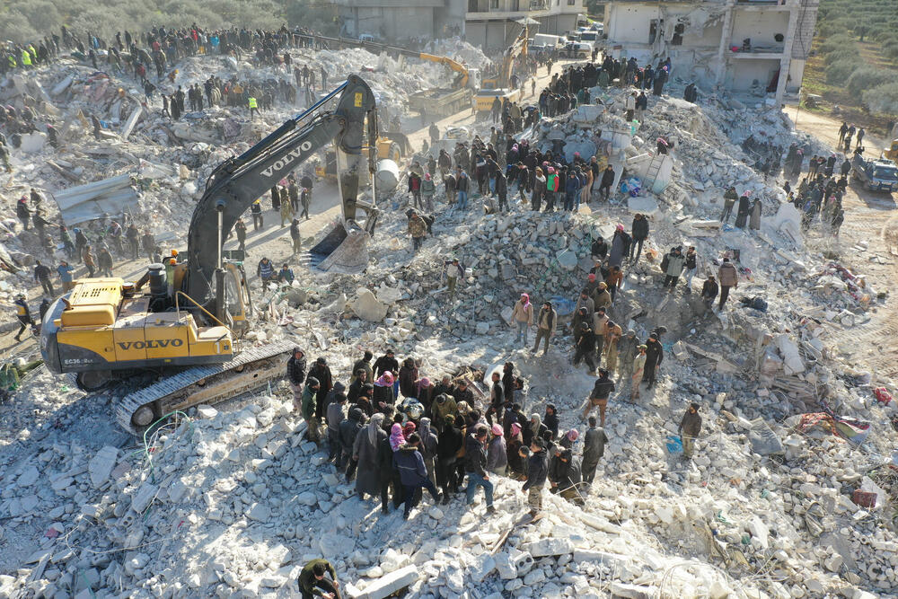 Rescue teams searching the rubble for survivors in Idlib province, northwest Syria