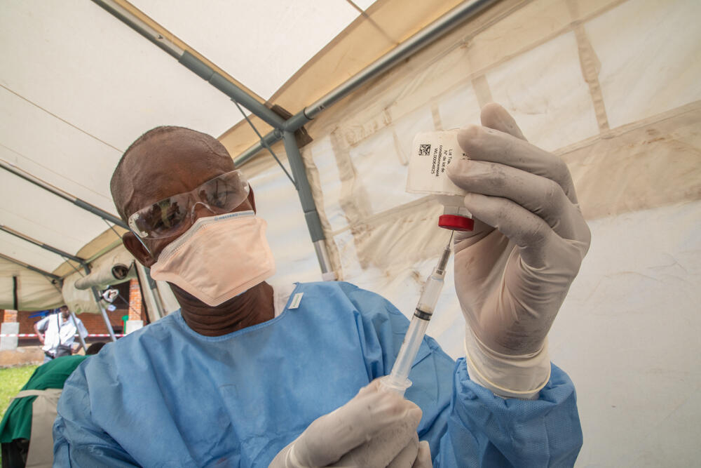 An MSF nurse prepares an Ebola vaccine in Bikoro