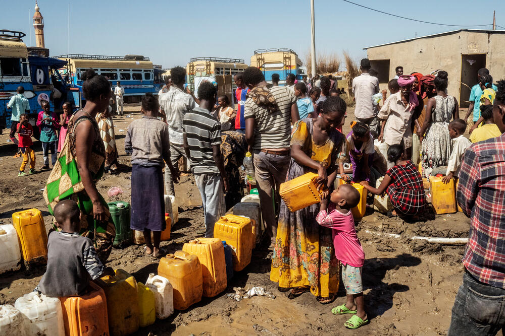 Refugees at a water point in Al Hashaba transit camp in Sudan
