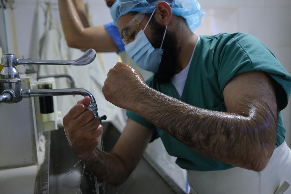 MSF surgeon Dr Mohammad Gul ‘scrubbing’ before performing surgery at Boost hospital, Lashkar Gah, Helmand Province, Afghanistan.