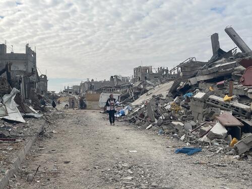 MSF’s Nadia Abo Malloh walking through the ruins of Rafah city, southern Gaza, Palestine.