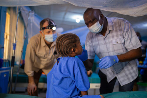 <p>Dr Kefas and Dr Dave examine a young girl with noma who underwent life-changing reconstructive surgery. Nigeria, October 2023.</p>