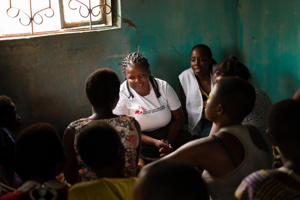 MSF nurse mentor Chrissie Nasiyo (middle) along with another MSF staff member talking to a group of sex workers during an outreach clinic in Nsanje.