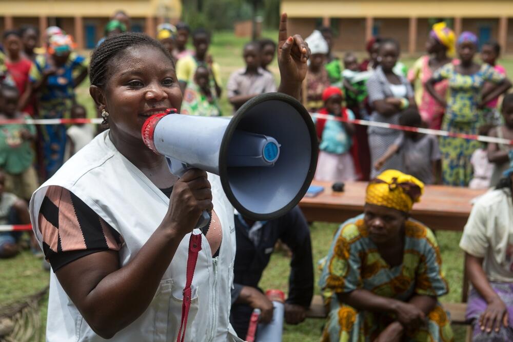 An MSF health promoter announcing a community session in Walikale, Democratic Republic of Congo