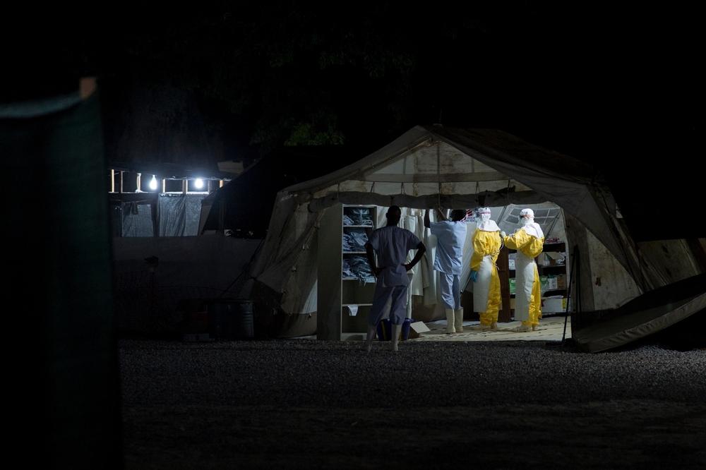 MSF teams working through the night to care for patients at an Ebola treatment centre in 2014, during Guinea’s last outbreak