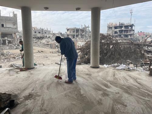 Man cleaning the rubble inside the Emirati hospital in Rafah city, southern Gaza, Palestine.