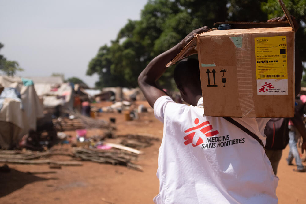 An MSF staff member transports medicines and water purification materials to the Bondeko Health Centre in Ndu, DRC.