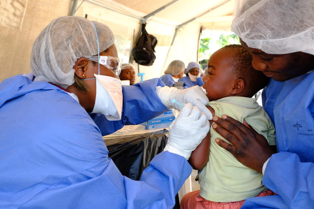 A toddler receives the investigational Ebola vaccine, rVSV-ZEBOV, at a vaccination point set up in the community of Kimbangu in the city of Beni.