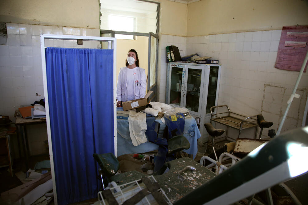 An MSF staff member inspects the delivery room of the health centre in Sebeya town, badly damaged by rocket fire