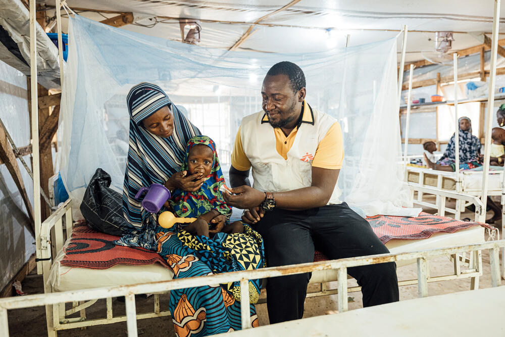 Hadisa Haman, 32, and her daughter Zainab Osuman, two, with head nurse Salifou Mohamadou at the malnutrition ward of Magaria District Hospital which MSF supports.