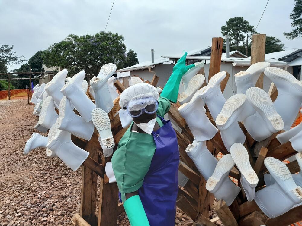 At an Ebola treatment centre, a hygienist decontaminates boots used as part of staff PPE