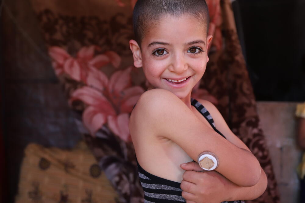 Moussa, a young diabetes patient in Lebanon, shows her continuous glucose monitoring device.