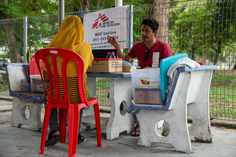 An MSF staff member registers a patient outside the MSF mobile clinic in Bukit Gudung, Penang.