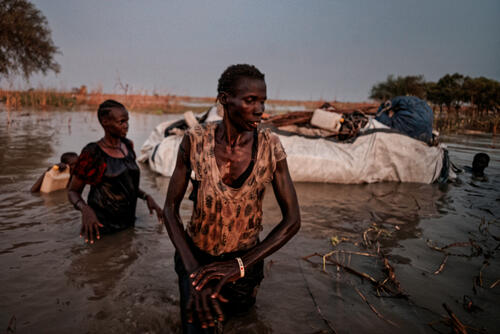 A family arrive at Bentiu camp after walking through the food waters for four days