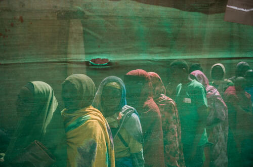 Survivors queuing at a border crossing point between Sudan and Chad where more than 600,000 people have fled in search of safety (April 2024)