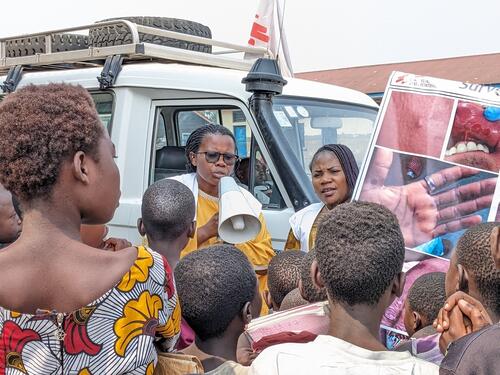 An MSF community health education team raise awareness about mpox at a camp for displaced people in the east of the DRC