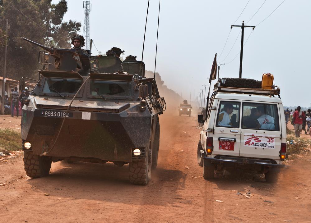 An MSF Land Cruiser passes by a military vehicle during unrest in Bangui, Central African Republic