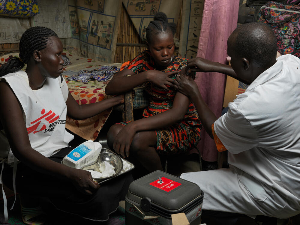 In Bentiu, a medical team vaccinate a woman against hepatitis E as part of the mass campaign