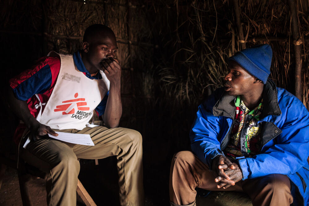 Dieudonné Ngandru Lossi (right), 32, widower, speaks with Djapan in his straw shelter at the Rho IDP site, Djugu territory, Ituri Province, 10 November 2019. 