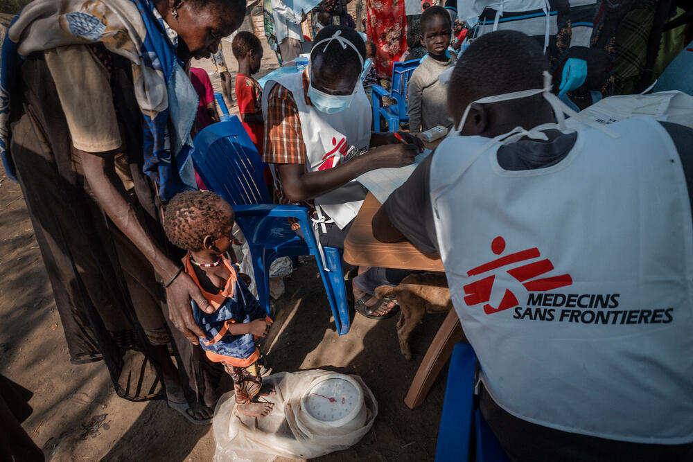 A child is weighed at an MSF mobile clinic in Rubkona