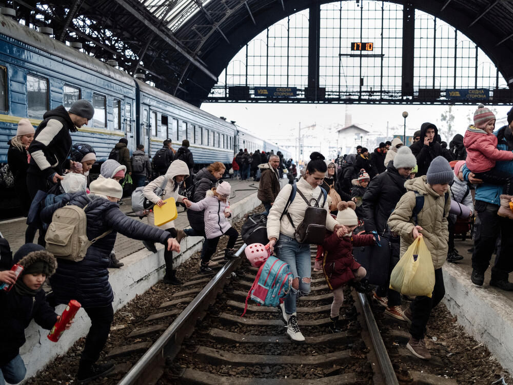 Hundreds of people trying to escape the war in Ukraine wait for a train to Poland at the central train station in Lviv. 27 February 2022.