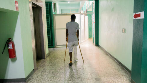 Photo of a man in a hospital with crutches